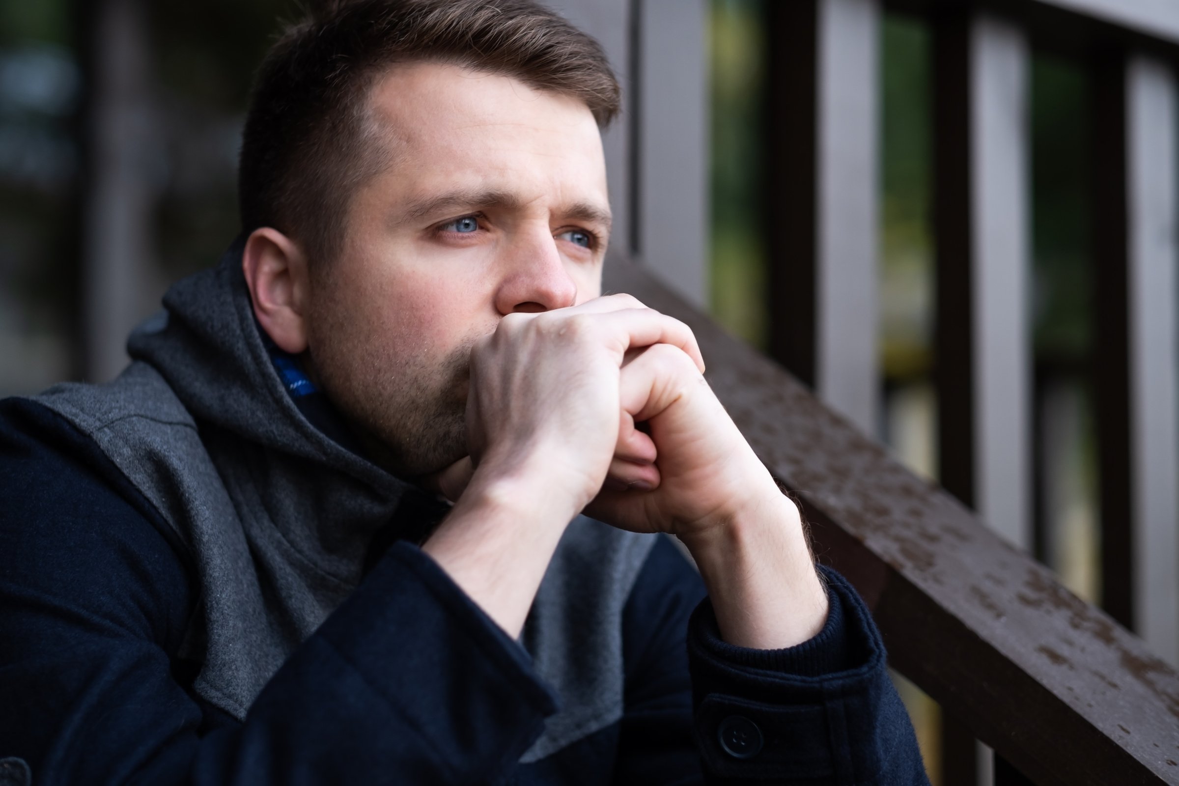 sad caucasian man sitting alone and thinling about problems.